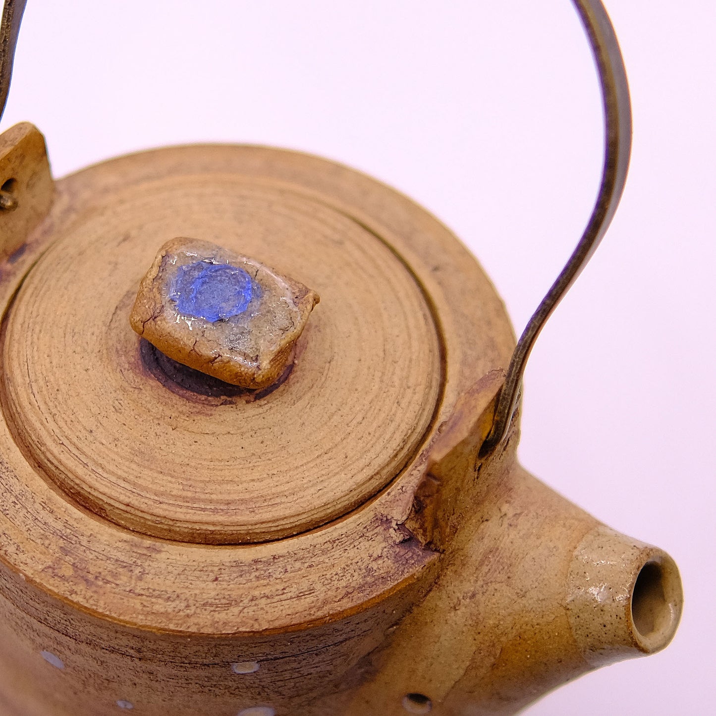 Rustic teapot with metal handle